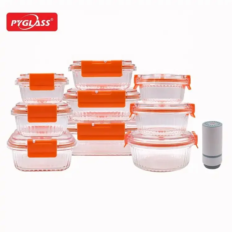 Pyglass kitchen storage containers with orange lids, various sizes, stacked in two groups, with additional cylindrical item.